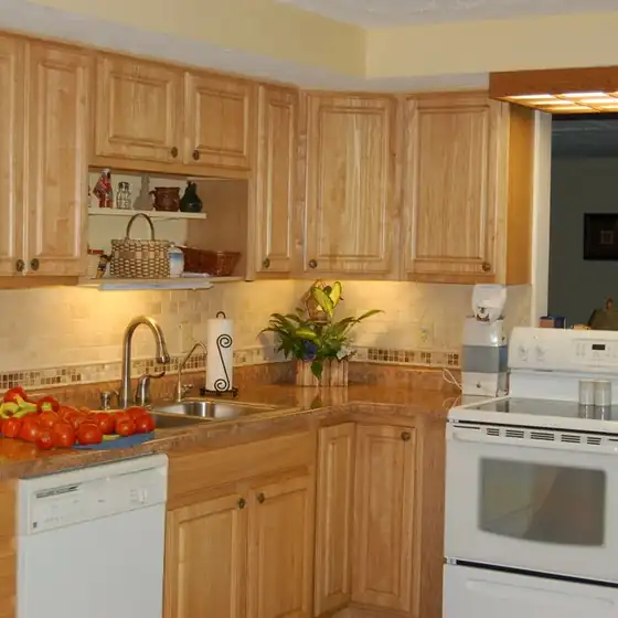 Kitchen with honey oak cabinets, a white range and a tiled backsplash