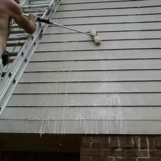 Paint roller on house siding